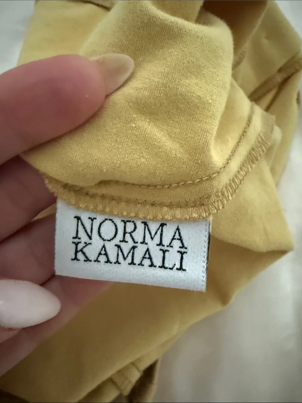 Norma Kamali , bodysuit Button-Front One-Piece in Mustard Yellow